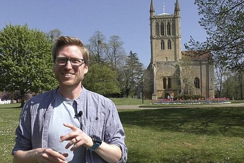 Dan Boatright-Greene standing in front of Pershore Abbey